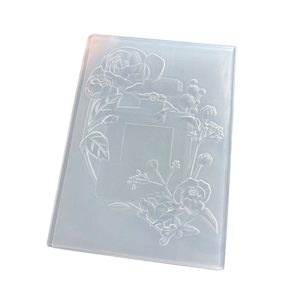 A translucent plastic photo frame mold with embossed floral designs and a central blank frame area, shown on a plain white background.