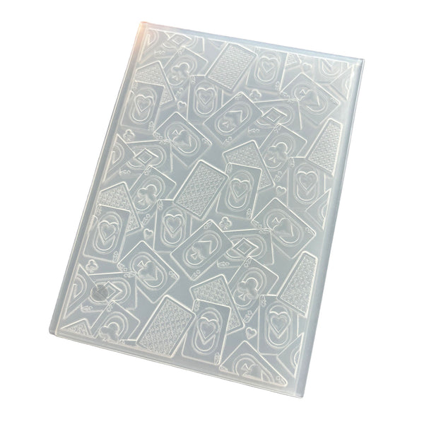 A clear plastic stamping or embossing plate featuring a repeating pattern of hearts and geometric shapes, shown on a plain white background.