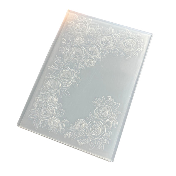 A translucent frosted glass or acrylic panel with an embossed floral rose border design, shown at an angle on a white background.
