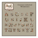 Alphabet letters with a floral pattern on a beige background, featuring the brand 'Cocoa-colored Moments'.