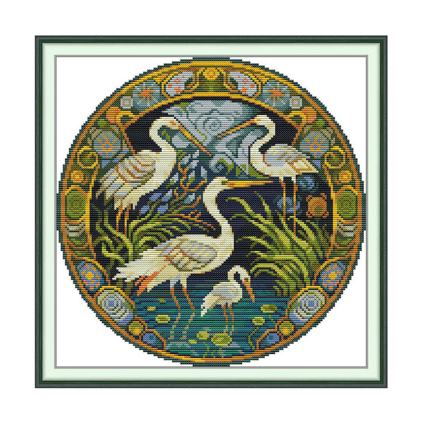 Decorative circular design with cranes and nature elements, framed.