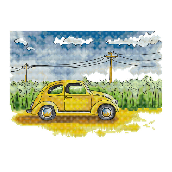 Yellow vintage car on a road with a blue sky and green fields in the background