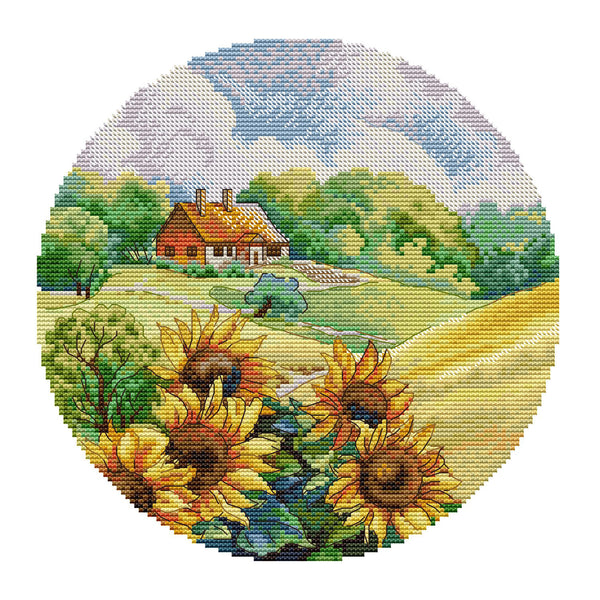 Round needlepoint canvas with sunflowers and a cottage in the background