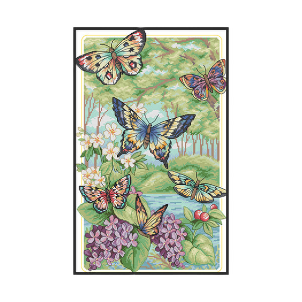 Framed artwork of butterflies and flowers with a scenic background