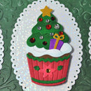 Decorative Christmas tree cupcake with red and green colors on a textured green background