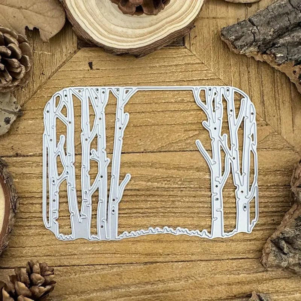 Metal tree-shaped cutting die on a wooden surface with natural elements.