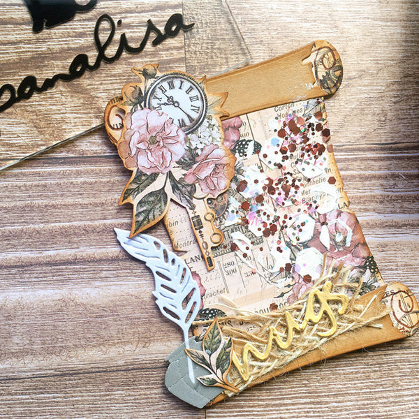Decorative paper craft with floral elements and text on a wooden surface