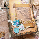 Decorative card with floral elements and 'blessed' text on a wooden surface.