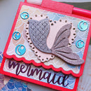 Card with a mermaid tail design and 'mermaid' text on a decorative background