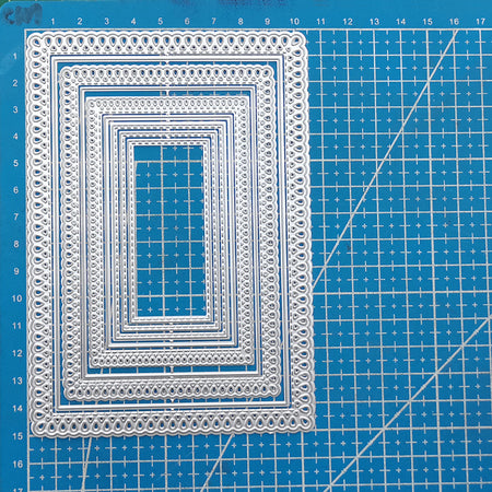 Set of decorative paper cutting mats on a blue grid background