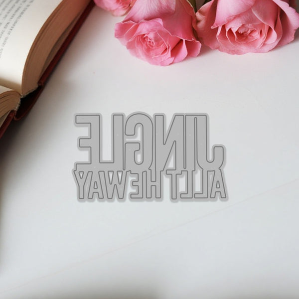 Decorative cutout letters spelling 'All the light ways' on a white surface with pink roses.
