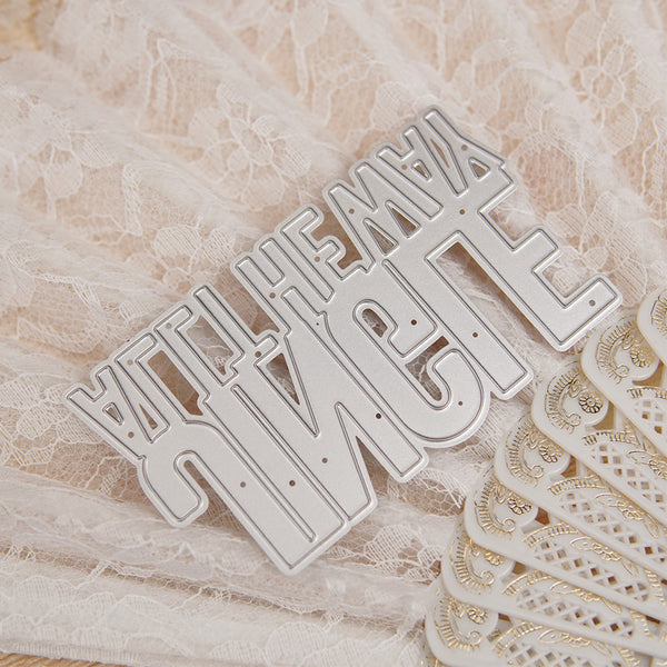 Metallic lettering on a textured surface with lace