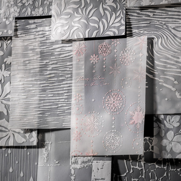 Decorative paper with snowflake patterns on a textured surface