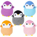 Set of five colorful crochet penguin toys on a white background