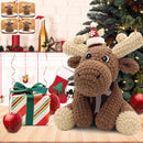 Knitted moose toy with a Santa hat in front of a Christmas tree and decorated fireplace.