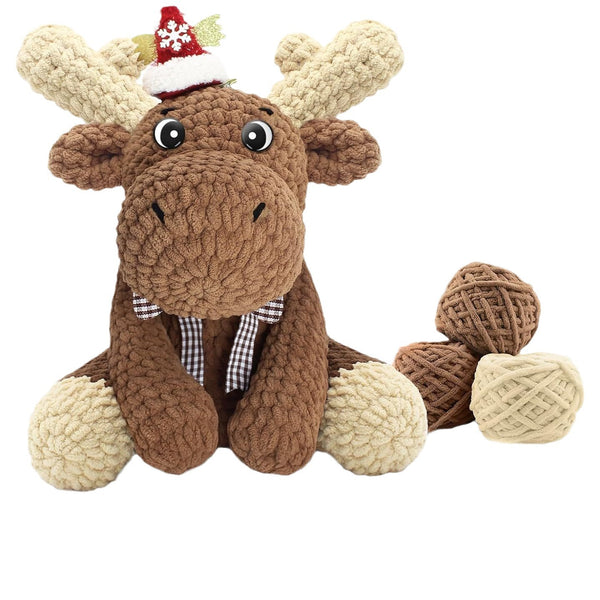 Plush moose toy with a Santa hat on a white background