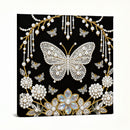 Decorative panel with butterflies, pearls, and flowers on a black background