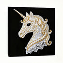 Decorative unicorn head with pearls and gold accents on a black background