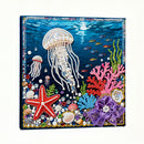 Decorative panel with beaded jellyfish, starfish, and coral on a blue background