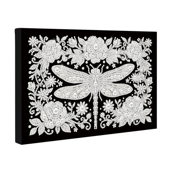 Decorative wall art with a dragonfly and floral design on a black background
