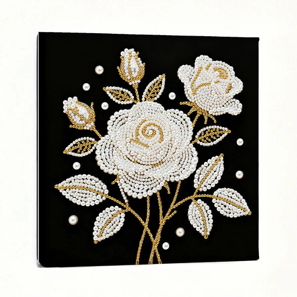 Decorative wall art with white and gold floral design on a black background