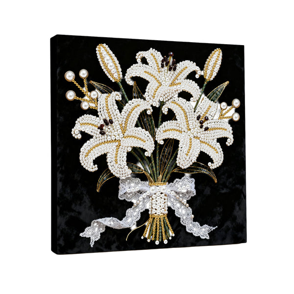Decorative wall art with white lilies and a bow on a black background