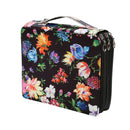 A rectangular zippered lunch bag or toiletry case with a black background and a vibrant multicolor floral print, featuring a top handle and dual side zippers.