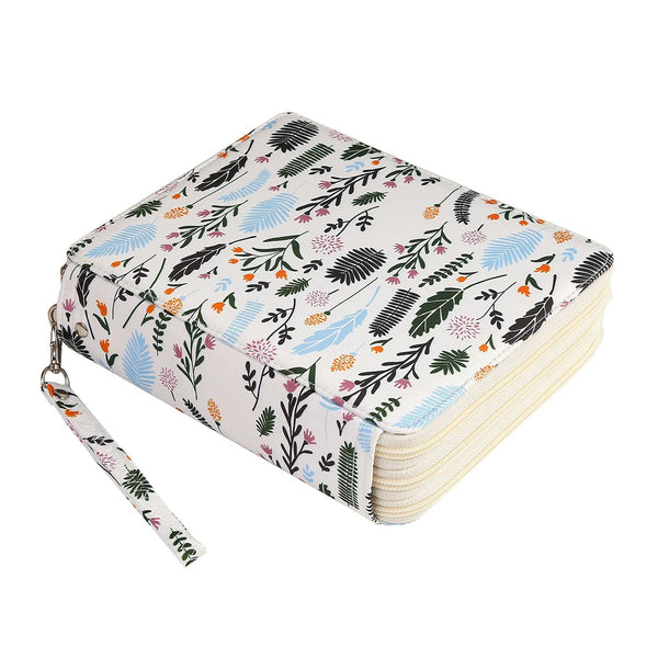 A hardcover notebook with a white cover decorated with a colorful tropical leaf and floral pattern, featuring a matching wrist strap and a stack of cream-colored pages.