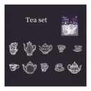 Black tea towel with white tea set illustrations and Savvy Creations logo.