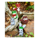 Collection of small crocheted animal toys on a natural wooden background