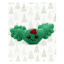 Green crocheted Holly Jolly Holly with a red flower on a white background with Christmas tree pattern.