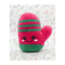 Crocheted pink and green Mitten amigurumi with a floral christmas background