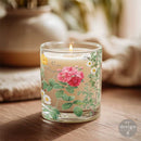 Candle in a glass holder with floral design on a wooden surface
