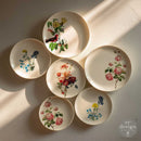 Set of decorative plates with floral designs on a light background