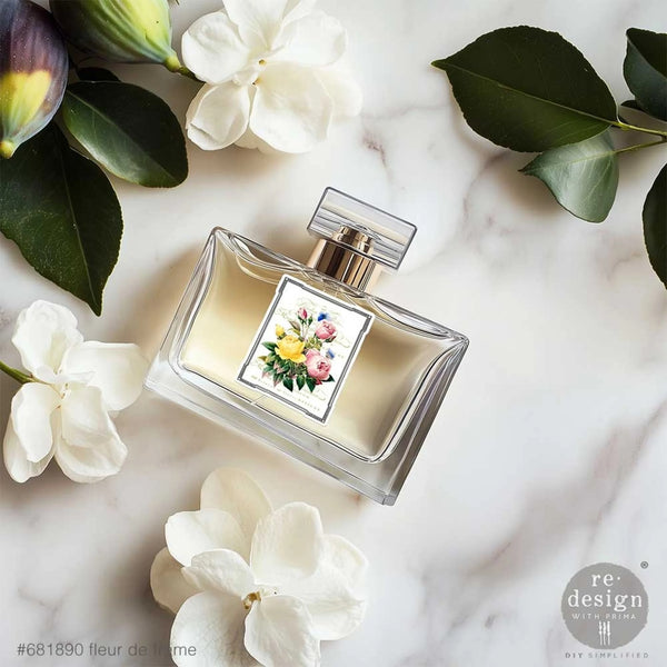 Perfume bottle with floral design on a marble surface with flowers and leaves