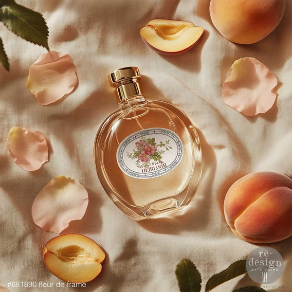 Perfume bottle with floral label surrounded by peach slices and petals on a textured surface