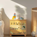 Wooden dresser with illustrated design in a bedroom setting
