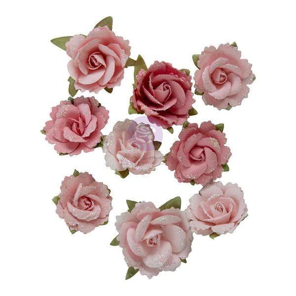 A set of artificial pink rose flower embellishments with green leaves, arranged on a plain white background.