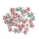 A cluster of small artificial flower embellishments in pastel pink, mint green, and white, arranged on a plain white background.