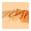 Textured fabric swatch in orange on a peach background