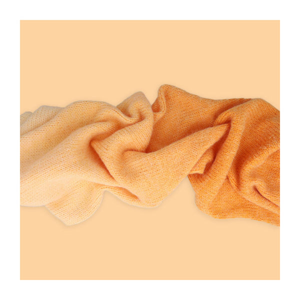 Textured fabric swatch in orange on a peach background