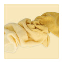 Yellow textured fabric on a light yellow background