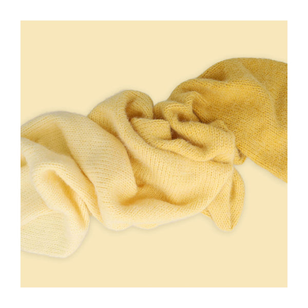 Yellow textured fabric on a light yellow background