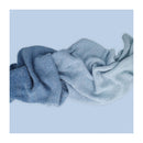 Folded blue fabric on a light blue background