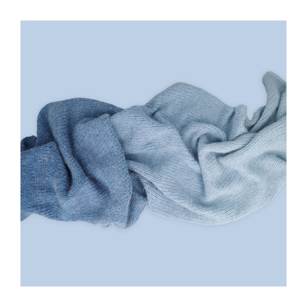 Folded blue fabric on a light blue background
