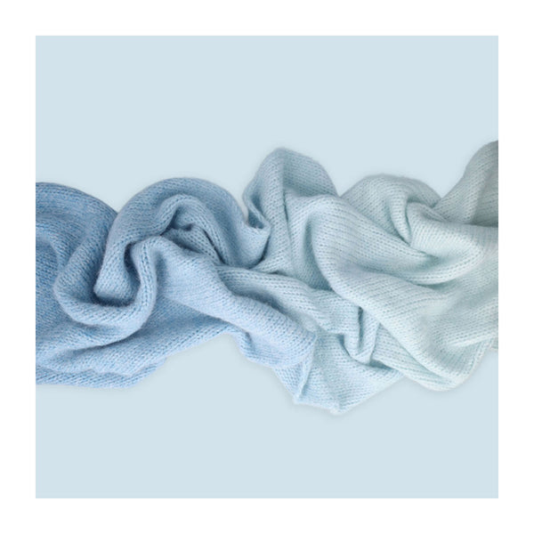 Light blue textured fabric on a light blue background