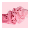 Pink knitted headband on a pink background