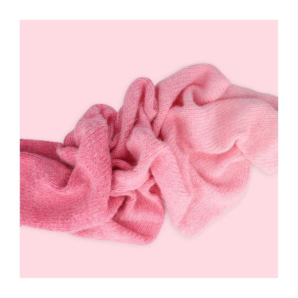 Pink knitted headband on a pink background