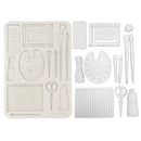 Set of white craft tools including scissors, brushes, and frames on a white background