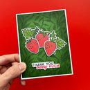 Card with strawberry design and 'Thank you berry much' text held against a red background